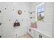 Functional mud room featuring shiplap walls, storage bench, hooks, and natural light at 10757 Timberdash Ave, Highlands Ranch, CO 80126