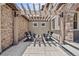 Inviting outdoor space with pergola, stone walls, and comfortable seating around a central fire pit at 10757 Timberdash Ave, Highlands Ranch, CO 80126