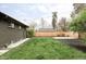 A spacious backyard featuring a newly-built fence, freshly mowed lawn, and charming landscaping at 1330 Olive St, Denver, CO 80220