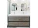 Elegant bathroom featuring double sink vanity with modern lighting and round gold mirrors at 1330 Olive St, Denver, CO 80220