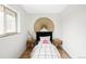 Cozy bedroom showcasing simple decor, natural light, and hardwood flooring at 1330 Olive St, Denver, CO 80220
