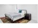 Cozy bedroom with metal bed frame, soft rug, and a serene atmosphere at 1330 Olive St, Denver, CO 80220