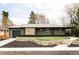 Charming single-story home with a landscaped front yard and a brick exterior at 1330 Olive St, Denver, CO 80220