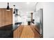 Spacious kitchen featuring stainless steel appliances and wood flooring at 1330 Olive St, Denver, CO 80220