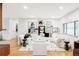 Spacious living room featuring hardwood floors, modern furnishings, and ample natural light at 1330 Olive St, Denver, CO 80220
