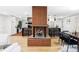 Open concept living room featuring a brick fireplace and wood floors at 1330 Olive St, Denver, CO 80220