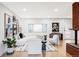 Bright living room with hardwood floors, white furniture, modern decor and a brick fireplace at 1330 Olive St, Denver, CO 80220