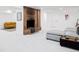 Cozy living area with brick fireplace, plush carpeting, and comfortable yellow sofa at 1330 Olive St, Denver, CO 80220