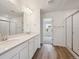 A modern bathroom features double sinks, vanity and a large glass-enclosed shower at 24790 E 39Th Ave, Aurora, CO 80019