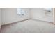 A large bedroom with neutral walls, and carpeting with two large windows at 24790 E 39Th Ave, Aurora, CO 80019