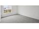 Cozy bedroom with soft carpet and a window offering views of the neighborhood at 24790 E 39Th Ave, Aurora, CO 80019