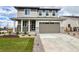 Charming two-story home with a two-car garage, well-manicured lawn, and inviting front porch at 24790 E 39Th Ave, Aurora, CO 80019