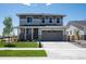 Inviting two-story home with a manicured lawn and attached two-car garage at 24790 E 39Th Ave, Aurora, CO 80019