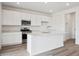 Modern kitchen featuring white cabinets, stainless steel appliances, and a kitchen island at 24790 E 39Th Ave, Aurora, CO 80019
