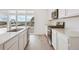 Modern kitchen featuring white cabinets, stainless steel appliances, and hardwood flooring at 24790 E 39Th Ave, Aurora, CO 80019
