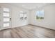 A bright living room with luxury vinyl flooring, neutral walls and large windows at 24790 E 39Th Ave, Aurora, CO 80019