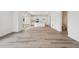 Open living space featuring hardwood flooring and all-white kitchen and bathroom at 24790 E 39Th Ave, Aurora, CO 80019