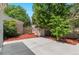 Backyard patio with mulched garden space and fence at 1011 S Valentia St # 3, Denver, CO 80247