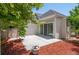 Backyard patio with sliding doors and mulched garden space at 1011 S Valentia St # 3, Denver, CO 80247