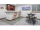 Finished basement featuring a bar area with seating and a small round table with stools at 1011 S Valentia St # 3, Denver, CO 80247