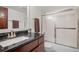 Bathroom features a vanity with granite countertop, and a shower with sliding glass doors at 1011 S Valentia St # 3, Denver, CO 80247