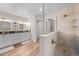 Bathroom featuring dual vanity, tile flooring, and a glass-enclosed shower with tiled walls and a corner bench at 1011 S Valentia St # 3, Denver, CO 80247