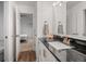 Bathroom with sleek black granite counters, modern fixtures, and door into bedroom at 1011 S Valentia St # 3, Denver, CO 80247