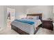 Bedroom featuring a substantial bed frame, plush carpets, and view into an organized walk-in closet at 1011 S Valentia St # 3, Denver, CO 80247