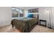 Bright bedroom with large window, comfortable bed, side table, and artwork at 1011 S Valentia St # 3, Denver, CO 80247
