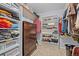 Organized walk-in closet features built in shelves, drawers, cabinets, and ample storage space at 1011 S Valentia St # 3, Denver, CO 80247