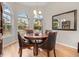 Dining room with hardwood floors, round table, and large windows offering scenic views at 1011 S Valentia St # 3, Denver, CO 80247