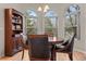 Bright dining room with hardwood floors, three windows and a display cabinet at 1011 S Valentia St # 3, Denver, CO 80247