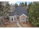Charming brick home featuring a turret-style room, complemented by mature trees and manicured landscaping at 1011 S Valentia St # 3, Denver, CO 80247