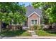 Inviting brick home featuring landscaped yard and walkway leading to the entrance at 1011 S Valentia St # 3, Denver, CO 80247