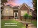 Charming single-story home featuring a brick facade, manicured lawn, and inviting walkway at 1011 S Valentia St # 3, Denver, CO 80247