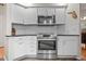 Bright kitchen with stainless steel range, granite counters and white cabinets at 1011 S Valentia St # 3, Denver, CO 80247
