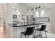 Bright kitchen with black granite countertops, white cabinets, island with seating, and stainless steel appliances at 1011 S Valentia St # 3, Denver, CO 80247