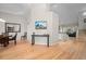 Open-concept living area with hardwood floors, neutral walls, and seamless flow into the kitchen at 1011 S Valentia St # 3, Denver, CO 80247