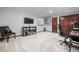 Finished basement office space, featuring neutral carpet, bright walls, and a dark wood bookcase at 1011 S Valentia St # 3, Denver, CO 80247