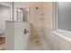 Shower with tiled walls, tiled floors, a glass door, and built in shelves at 1011 S Valentia St # 3, Denver, CO 80247