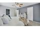 Bright bedroom features a modern ceiling fan, white dresser and decor at 9080 Gale Blvd # 4, Thornton, CO 80260