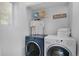 Well lit laundry room with front loading washer, dryer, shelf and window at 9080 Gale Blvd # 4, Thornton, CO 80260