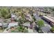 An aerial view of a charming neighborhood with mature trees and a mix of residential and commercial buildings at 3031 W 20Th Ave, Denver, CO 80211