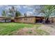 Spacious backyard with a brick home, patio, and lush green grass at 3031 W 20Th Ave, Denver, CO 80211