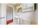 Bright bathroom with a single sink, white tile, and toilet at 3031 W 20Th Ave, Denver, CO 80211
