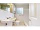 Bright white bathroom with a single sink, tiled walls, and tub at 3031 W 20Th Ave, Denver, CO 80211