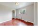 Bedroom featuring neutral walls, bright window, and classic wood floors at 3031 W 20Th Ave, Denver, CO 80211