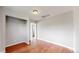 A bright bedroom with a closet, light gray walls, and red wood flooring at 3031 W 20Th Ave, Denver, CO 80211