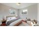 Cozy bedroom with neutral walls, two bright windows, and natural wood floors at 3031 W 20Th Ave, Denver, CO 80211