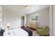 Cozy bedroom featuring natural light, light wood dresser, and a sitting chair at 3031 W 20Th Ave, Denver, CO 80211